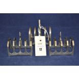 A pair of silver five-bar toast racks, by Edward Viners, Sheffield 1936; together with another,