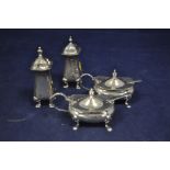 Four silver condiments, to include: two baluster pepperettes,