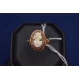 A carved shell cameo ring, c.1880, the female bust within floral mount, ring size N.