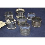 Six silver napkin rings, various designs; and one plates napkin ring.