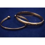 Two 9ct. yellow gold bangles, one part-engraved with foliate design, 19.2grms gross.