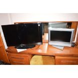 A Samsung flatscreen TV; and a small Toshiba integrated digital TV, both with remote controls.