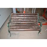 A modern cast iron and wooden slatted garden bench seat, 124cms wide.