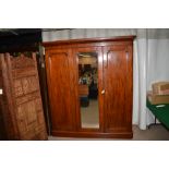 A Victorian mahogany three door wardrobe with fitted interior.