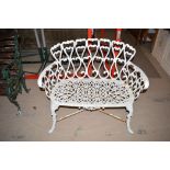 A modern white painted cast iron garden seat, 96cms wide.