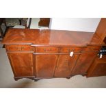 A reproduction inlaid mahogany Regency style breakfront sideboard, 154cms.