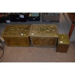 A pair of brass slipper boxes; and another brass box.