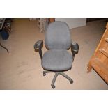 An office chair upholstered in grey material.