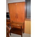 A G-Plan three-piece bedroom suite, comprising: wardrobe, kneehole dressing table with mirror over,