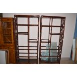 Two stained bamboo open display units with glass shelves, 92cms wide.