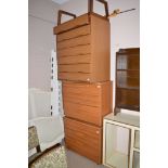 A teak effect melamine chests c.1970's of drawers; and another chest of drawers.
