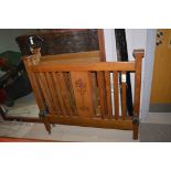 A single rail end bed with carved Arts & Crafts centre panel, 107cms.