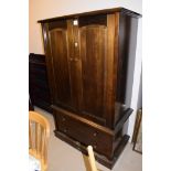 A mahogany finish low gentleman's wardrobe fitted two drawers,