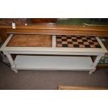 A painted and distressed coffee table with chequer board finish, 140cms wide.