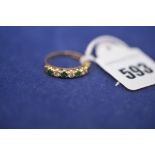 A yellow metal half hoop eternity ring set with emeralds and diamonds, indistinctly hallmarked,