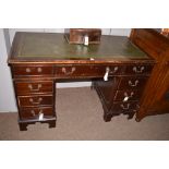 A mahogany twin pedestal desk with inset green leather writing surface, 122cms wide.