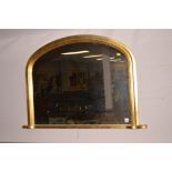 Gilt arched over mantel mirror, 103cms wide.