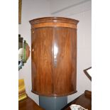 George III mahogany bowfront hanging corner cupboard.