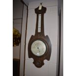 An Art Nouveau style stained oak aneroid barometer.