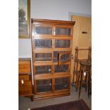 Rosewood finish sectional bookcase with glazed panel doors, 92cms wide.