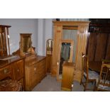 A light birch bedroom suite comprising dressing table, single mirrored wardrobe and bedside cabinet.