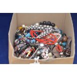 A quantity of costume necklaces, in a box.