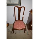 A pair of Edwardian inlaid mahogany nursing chairs.