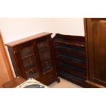 A contemporary mahogany glazed bookcase four drawers; together with an open stained bookcase,