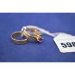 An 18ct. yellow gold wedding band, ring size N; and an 18ct.