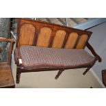 A George III fruitwood and oak five panel settle with loose cushions.