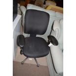 A modern black finish office chair on chromed wheel base.