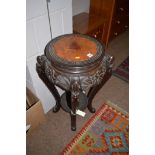 An ebonised carved and stained hardwood jardiniere stand in the oriental style top 36cms diameter.