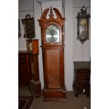 A modern light mahogany finish long case clock with glazed front two weights and pendulum.