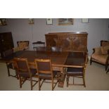 1940's carved oak dining room suite comprising sideboard with three carved doors,