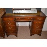 A mahogany pedestal desk with inset tooled green leather writing surface, 122cms.