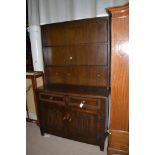 Oak stained dresser, two tier rack with two frieze drawers, linen fold panels below, 122cms wide.