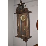 A stained walnut drop dial wall clock with two train movements,