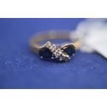 A sapphire and diamond ring, on 18ct. yellow gold shank, ring size N, 3.8grms gross.