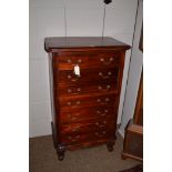 A modern mahogany upright chest of drawers in the Georgian style, 22cms wide.