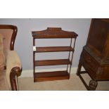 Mahogany Georgian style hanging wall shelves with shaped canopy and single draw, 66cms wide.