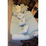 A pair of two seater light green finish settees and a matching arm chair.