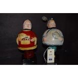 Two Chinese papier mache bobble-head figures.