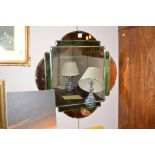 A green and bronze tinted art deco style wall mirror, 61cms.