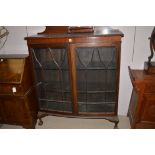 A mahogany bowfront astragal glaze china cabinet with ball and claw feet.