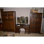 Stained oak three piece bedroom suite, comprising: a gentleman's wardrobe, ladies wardrobe,