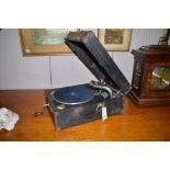 A wind up portable gramophone in black vinyl case, 43cms.