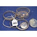 Silver bangles, some with engraved floral decoration; and two silver locket pendants, 3.9oz.