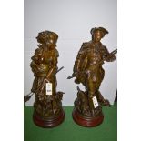 A pair of bronzed figures of a huntsman and shepherdess,