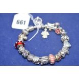 A silver Pandora charm bracelet with 21 charms, 93grms/3oz. gross.