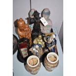 Wooden carvings and porcelain figures depicting Japanese figures; together with a brass Buddha;